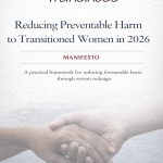 Cover page of a report titled “Reducing Preventable Harm to Transitioned Women in 2026.” The Transiness logo appears at the top, with a purple heart forming the dot of the letter “i.” Below, the title is set in clear serif text above the word “Manifesto.” A subtitle reads: “A practical framework for reducing foreseeable harm through system redesign.” At the bottom of the page, a soft, monochrome image shows two hands of different skin tones resting gently together, symbolising care and protection.